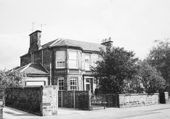 General view of the front facade of No. 17 with No. 15 obscured by a tree seen from the South West.