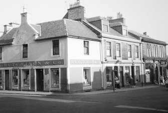 View of buildings at junction of Bridge Street and Cross Street.