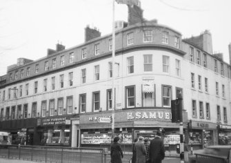 General view of shops on corner of High Street and East side of Reform Street.