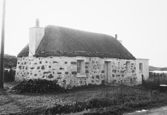 General view of thatched cottage.