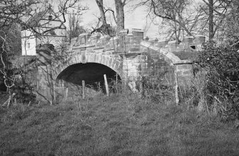 General view of Craigston Castle bridge with dovecot in background.