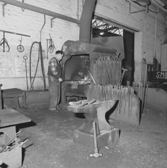 Glasgow, Springburn, St Rollox Locomotive Works, interior.
View of Blacksmith's hearth and anvil and some Blacksmith's tools.