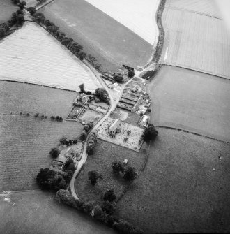 Oblique aerial view centred on church from ENE.