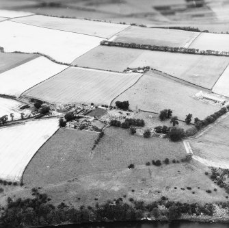 Oblique aerial view centred on church from SE.