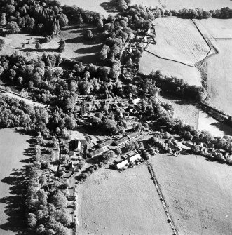 Oblique aerial view centred on the village of Longformacus with walled garden, church and burial ground adjacent, taken from the NNW.