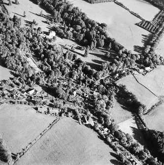 Oblique aerial view centred on the village of Longformacus with country house, walled garden, church and burial ground adjacent, taken from the WNW.