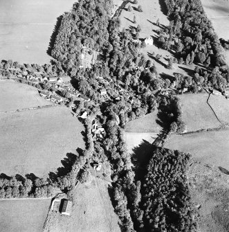 Oblique aerial view centred on the village of Longformacus with country house, walled garden, church and burial ground adjacent, taken from the SW.