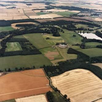 General oblique aerial view looking across the country house, stable, laundry, offices, museum and lake towards Coldstream and Coldstream Mains, taken from the W.