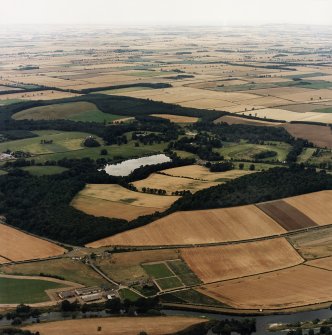 General oblique aerial view centred on the country house, stable, laundry, offices, museum and lake, taken from the SSW.