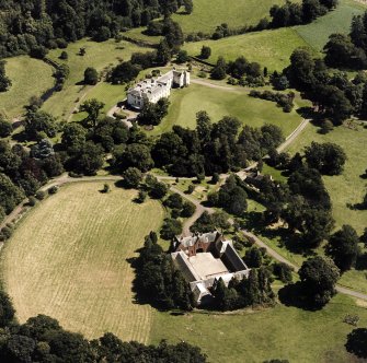 Oblique aerial view centred on the country house and stables, taken from the WNW.