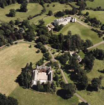 Oblique aerial view centred on the country house and stables, taken from the W.