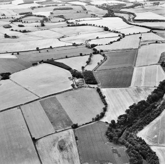 General oblique aerial view looking across the farmhouse and mill house towards the country house, taken from the E.
