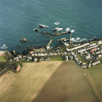 Oblique aerial view centred on the village and harbour, taken from the WSW.