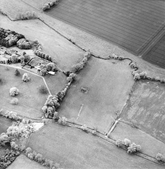 Oblique aerial view centred on the remains of the tower-house with cottage and walled garden adjacent, taken from the ESE.