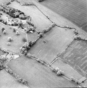 Oblique aerial view centred on the remains of the tower-house with cottage, walled garden and Stainrigg house adjacent, taken from the E.