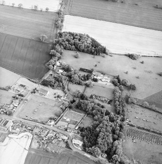 Oblique aerial view centred on the church, burial ground and walled garden, taken from the WNW.