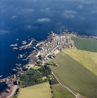 Oblique aerial view centred on the village, with the harbour adjacent, taken from the NW.