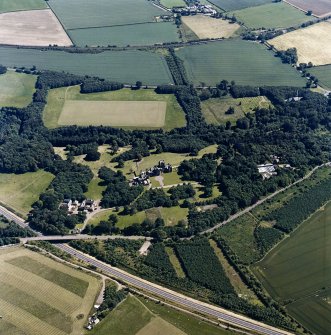 Oblique aerial view centred on the country house, with the farmsteading, the gate-lodge, the burial ground and the church adjacent, taken from the NNW.