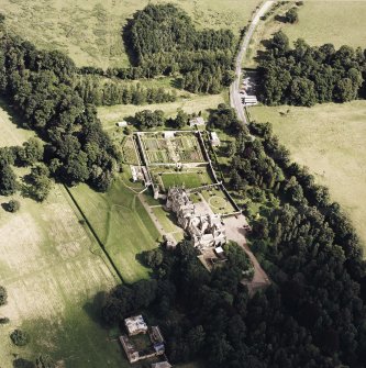 Oblique aerial view of Abbotsford centred on the country house with tea room, gardens and stables adjacent, taken from the WSW.