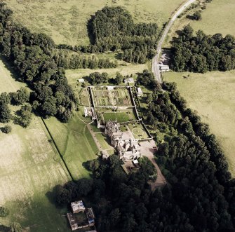 Oblique aerial view of Abbotsford centred on the country house with tea room, gardens and stables adjacent, taken from the SW.