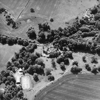 Oblique aerial view centred on the castle, tower-house and country house with the tower and walled garden adjacent, taken from the NE.
