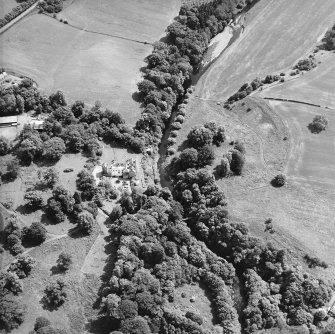 Oblique aerial view centred on the castle, tower-house and country house with the tower and walled garden adjacent, taken from the NNW.