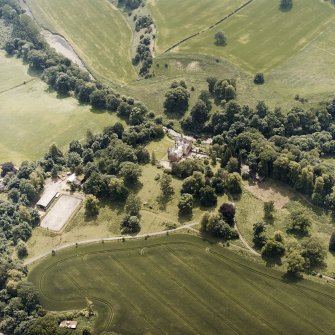 Oblique aerial view centred on the castle, tower-house and country house with the tower and walled garden adjacent, taken from the NNE.