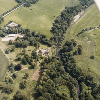 Oblique aerial view centred on the castle, tower-house and country house with the stables, tower and walled garden adjacent, taken from the NW.
