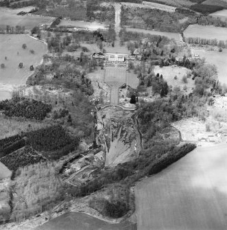 Oblique aerial view centred on the drained formal pond within Mellerstain House garden with country house and stables adjacent, taken from the SE.