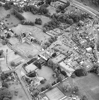 General oblique aerial view centred on Harmony house and the remains of the abbey, taken from the NW.