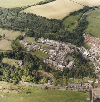 Oblique aerial view centred on the asylum and hospital, taken from the SE.