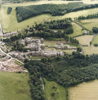 Oblique aerial view centred on the asylum and hospital, taken from the NNW.