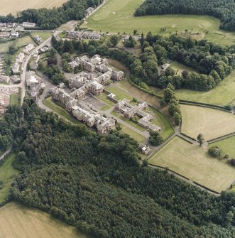 Oblique aerial view centred on the asylum and hospital, taken from the WNW.