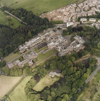 Oblique aerial view centred on the asylum and hospital, taken from the S.