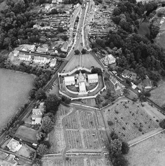 Oblique aerial view centred on the jail, burial ground and The Hermitage, taken from the SW.