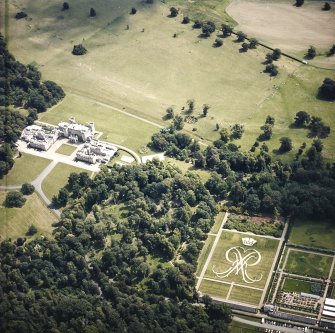 Oblique aerial view centred on the country house and formal garden.