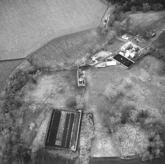 Oblique aerial view centred on country house from E.