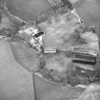 Oblique aerial view centred on country house from SE.