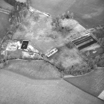 Oblique aerial view centred on country house from SSW.