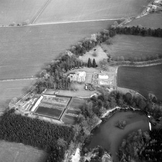 Oblique aerial view centred on country house from WSW.