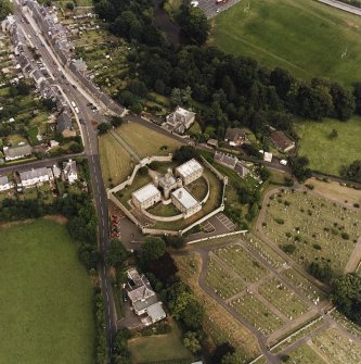 Oblique aerial view centred on the jail, burial ground and The Hermitage, taken from the WSW.