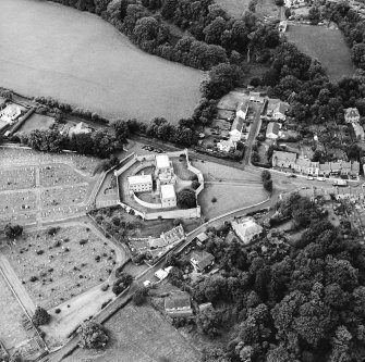 Oblique aerial view centred on the jail, burial ground and The Hermitage, taken from the ESE.