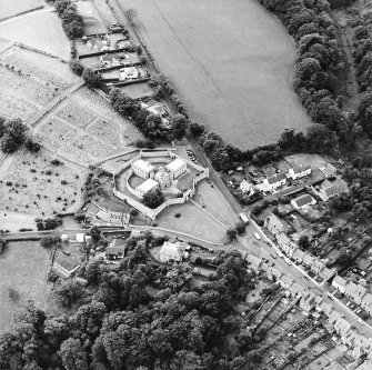 Oblique aerial view centred on the jail, burial ground and The Hermitage, taken from the ENE.