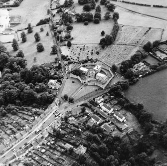 Oblique aerial view centred on the jail, burial ground and The Hermitage, taken from the NNW.