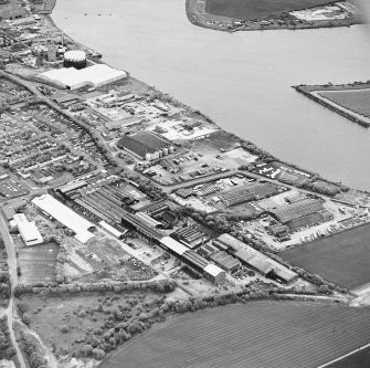 Oblique aerial view of southern Alloa and industrial units close to the River Forth, taken from the NW