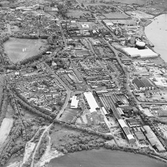 Oblique aerial view of southern Alloa and industrial units close to the River Forth, taken from the NW