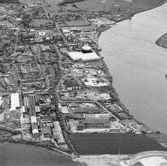 Oblique aerial view of southern Alloa and industrial units close to the River Forth, taken from the WNW