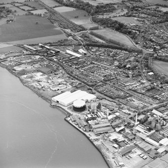 Oblique aerial view of southern Alloa and industrial units close to the River Forth, centred on the gasworks, taken from the SSE