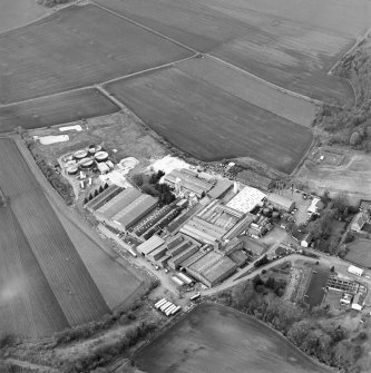 Oblique aerial view centred on the paper mill with the houses and office adjacent, taken from the ESE.