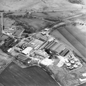 Oblique aerial view centred on the paper mill with the houses and office adjacent, taken from the WNW.